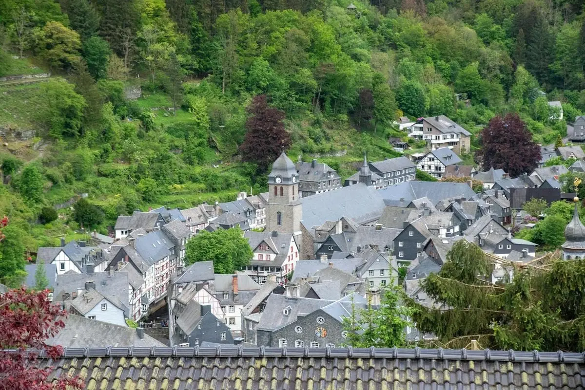 A picturesque aerial view of Monschau, Germany, surrounded by lush greenery.