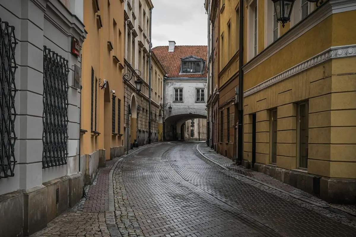 Cobblestone street in historic Warsaw, Poland on a cloudy day.
