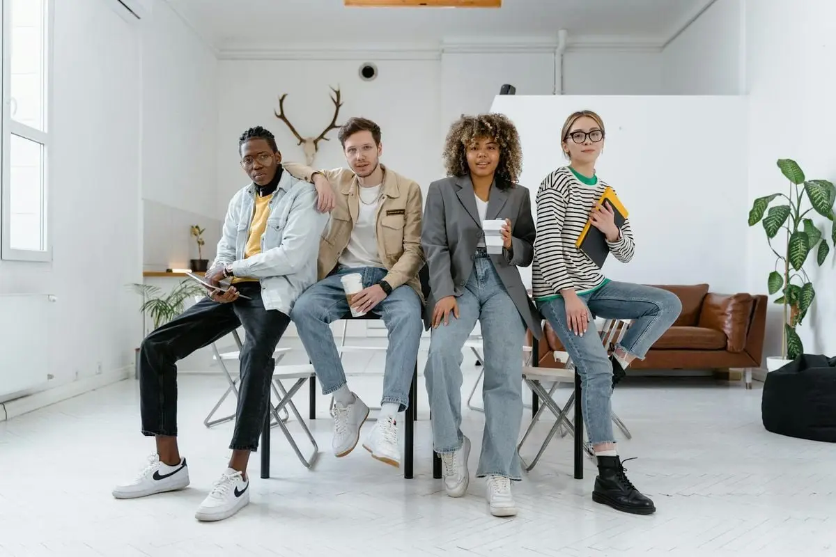 A multicultural group of young professionals in a modern office setting, showcasing teamwork and creativity.