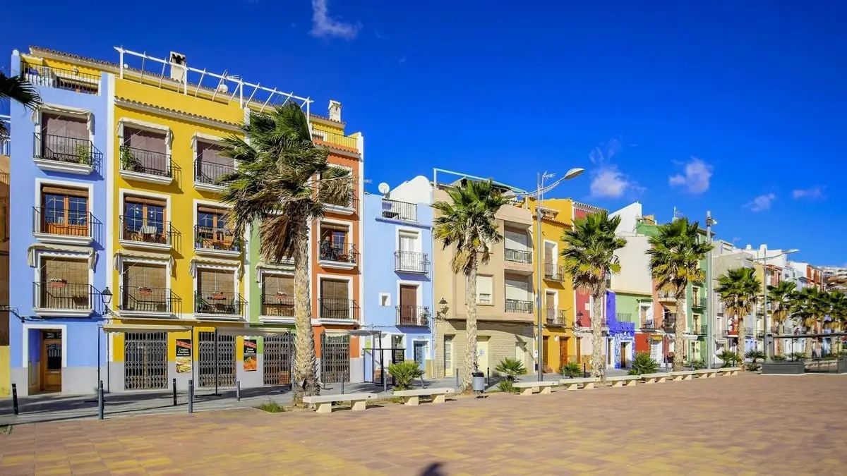 Vibrant colorful buildings on a sunny street in Villajoyosa, Spain.
