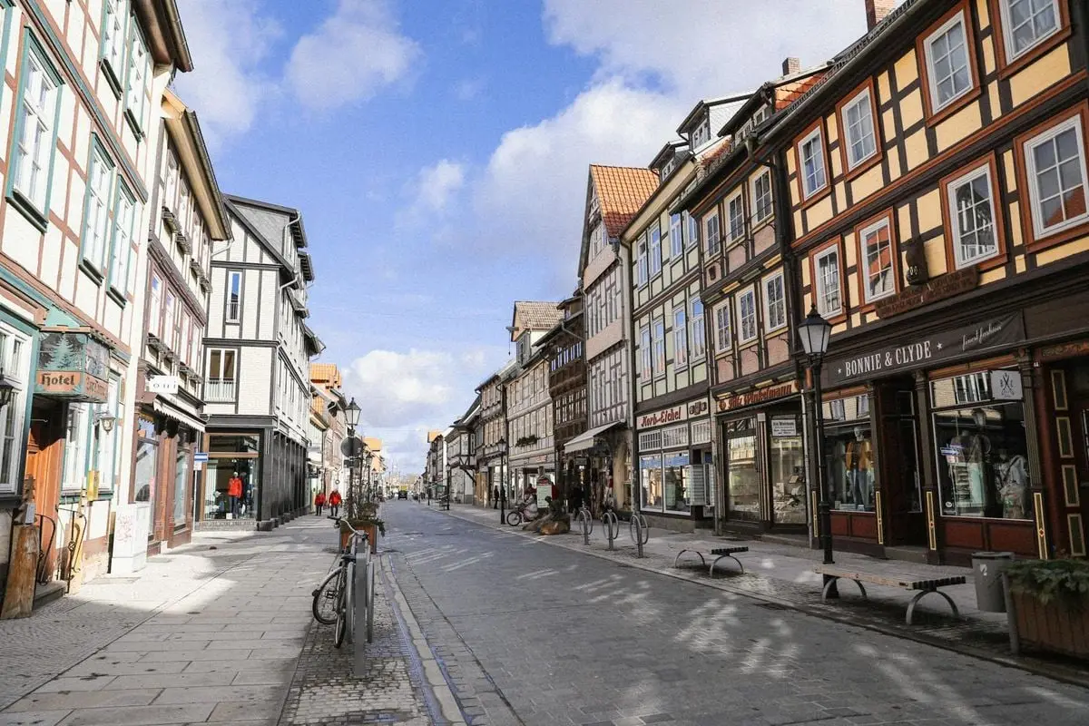 Scenic view of half-timbered buildings lining a historic street in Wernigerode, Germany, perfect for travel enthusiasts.