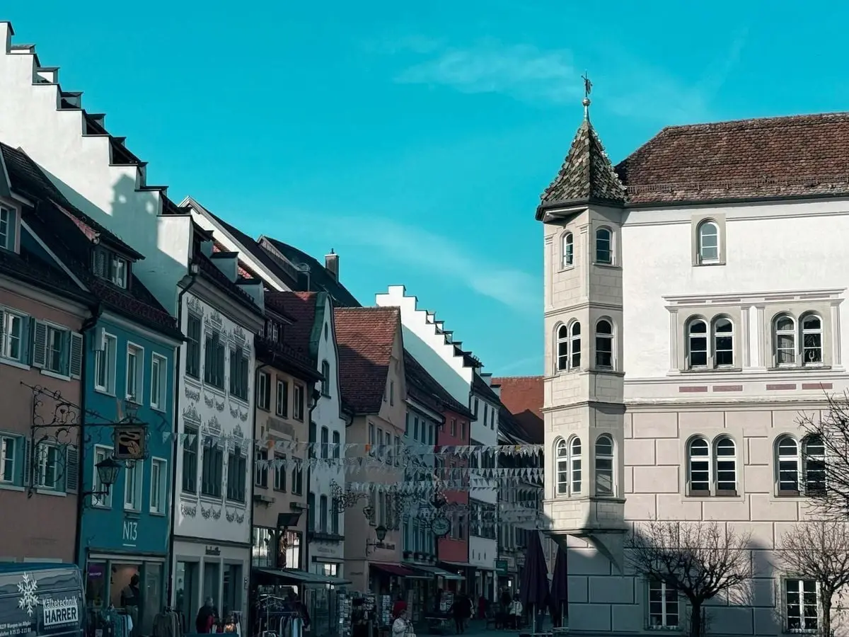 Picturesque Bavarian street showcasing traditional architecture under a clear blue sky.