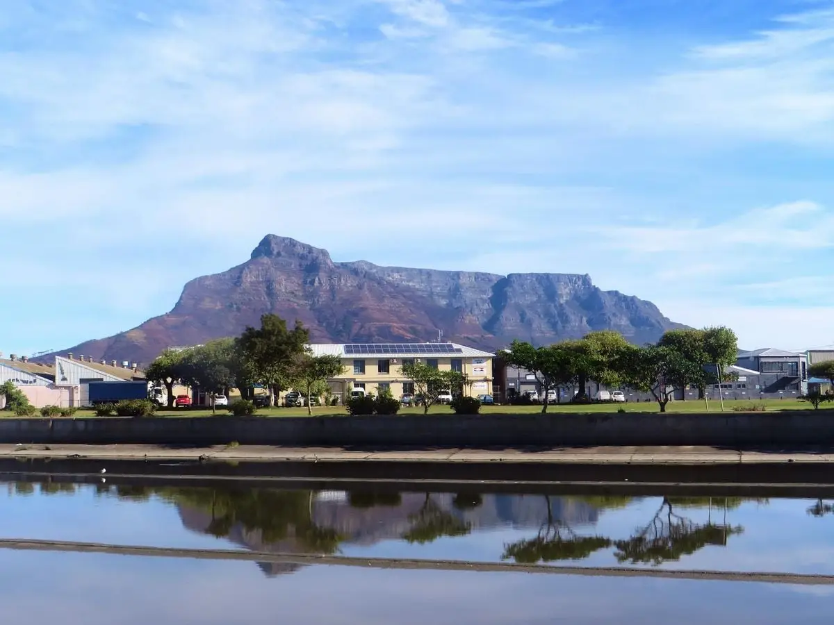 A picturesque view of Table Mountain with a reflection in the waters of Cape Town, South Africa.