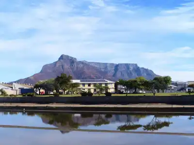 A picturesque view of Table Mountain with a reflection in the waters of Cape Town, South Africa.
