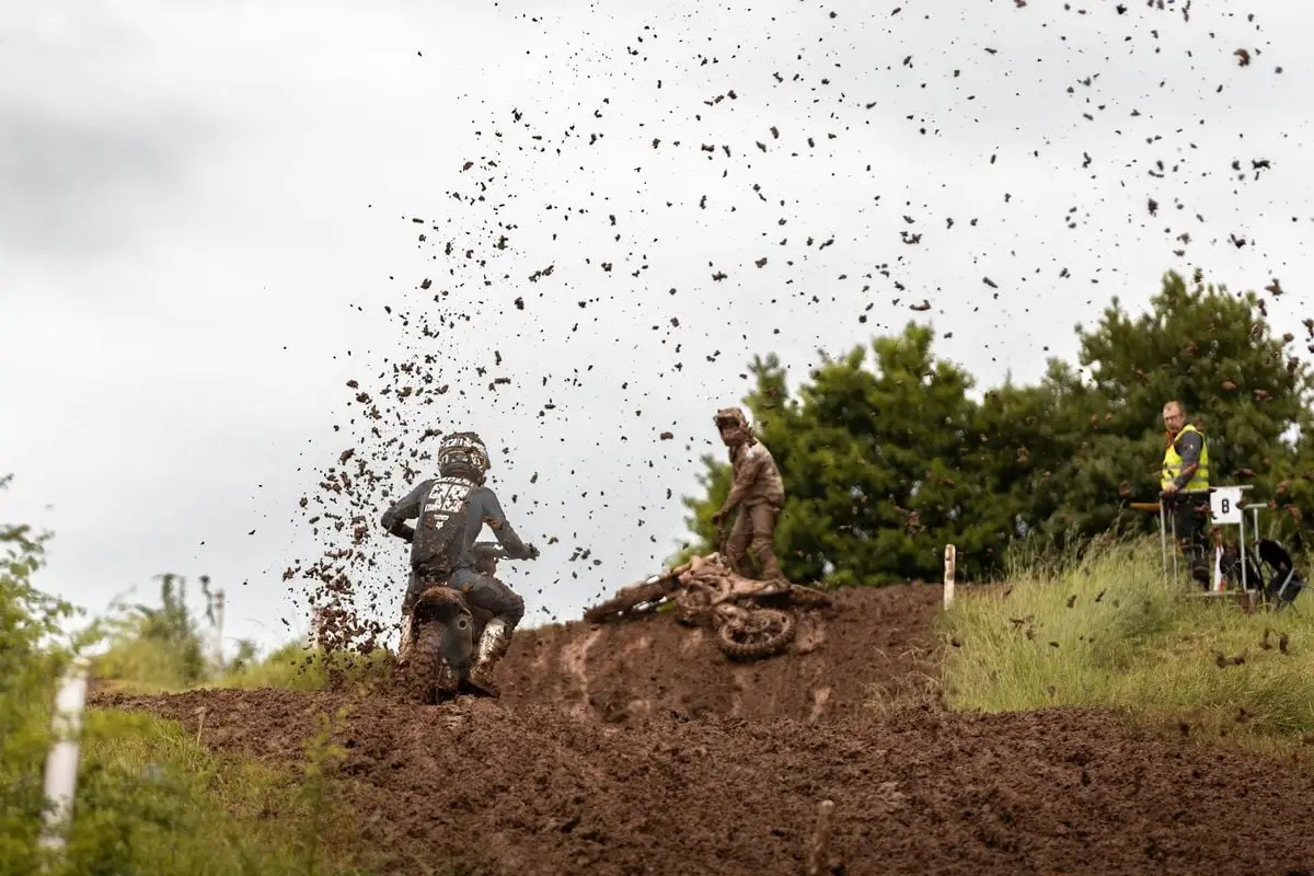 Exciting motocross event in muddy terrain, showcasing skill and adrenaline in Ansbach, Germany.