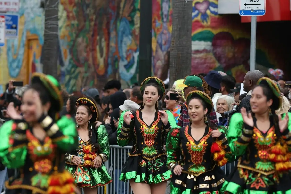 Vibrant street parade featuring dancers in traditional costumes celebrating cultural festivities.