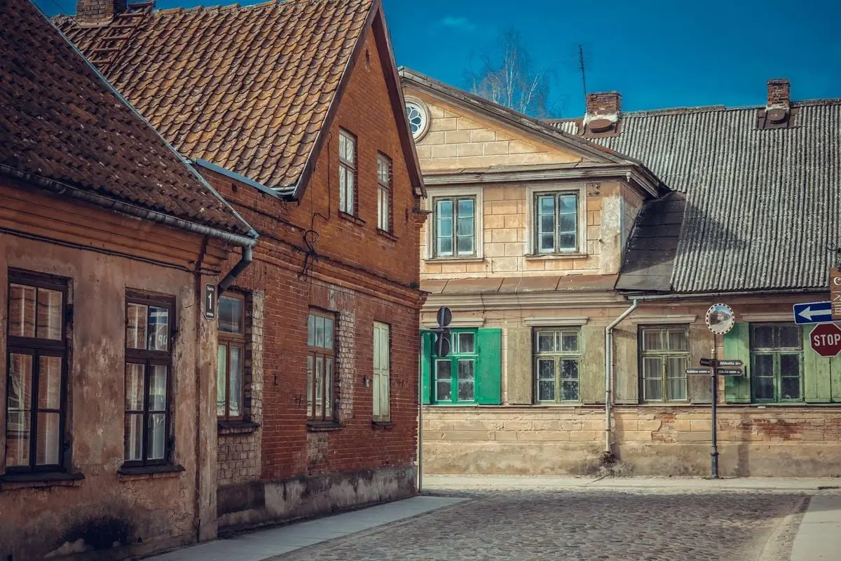 Explore the historic charm of medieval houses on a cobblestone street in Kuldīga, Latvia.