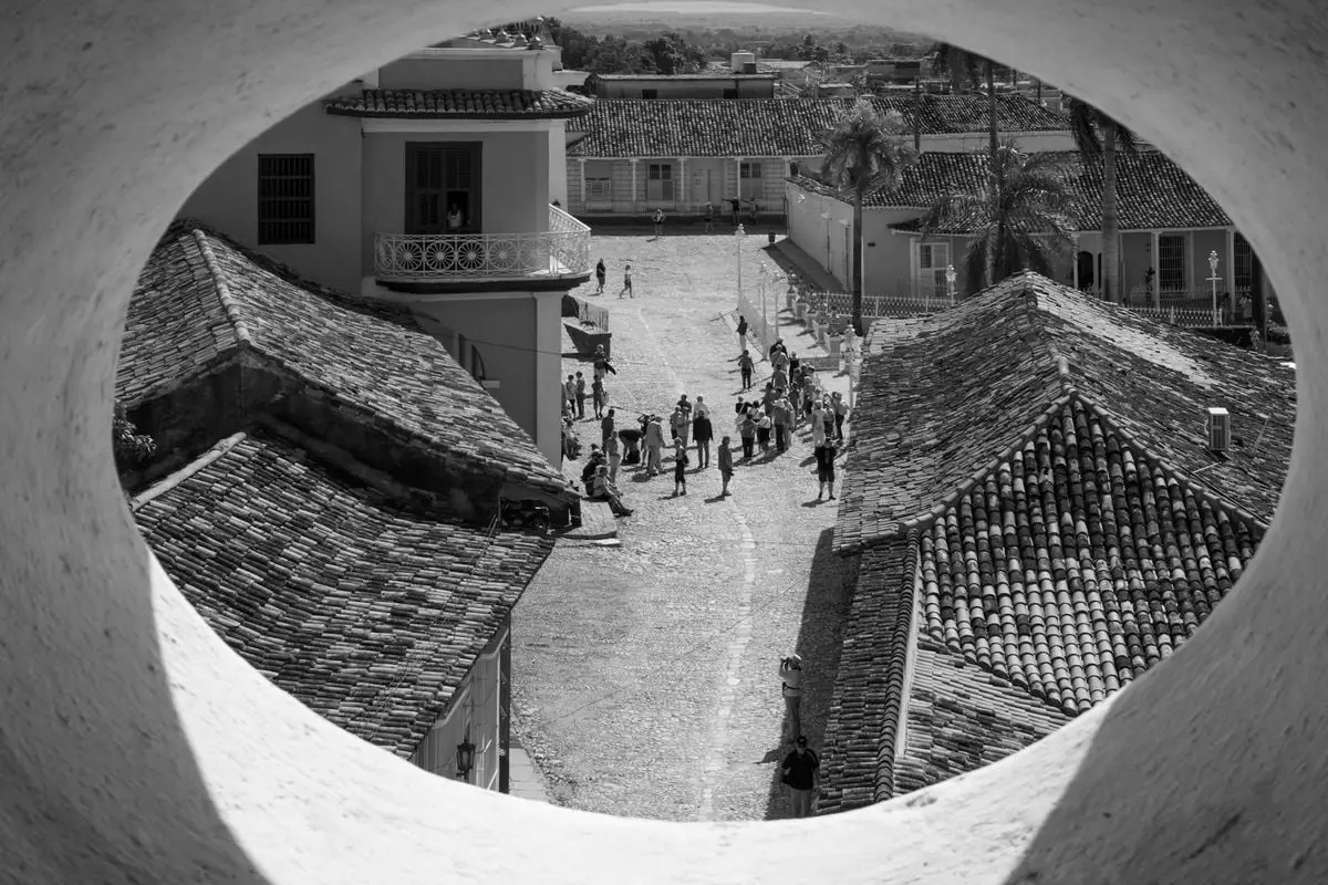 A captivating black and white view of a historic town's rooftops and cobblestone streets.