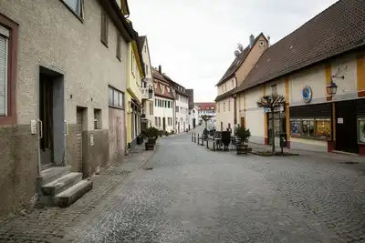 Charming cobblestone street in Weil der Stadt, Germany, showcasing traditional architecture and quaint buildings.