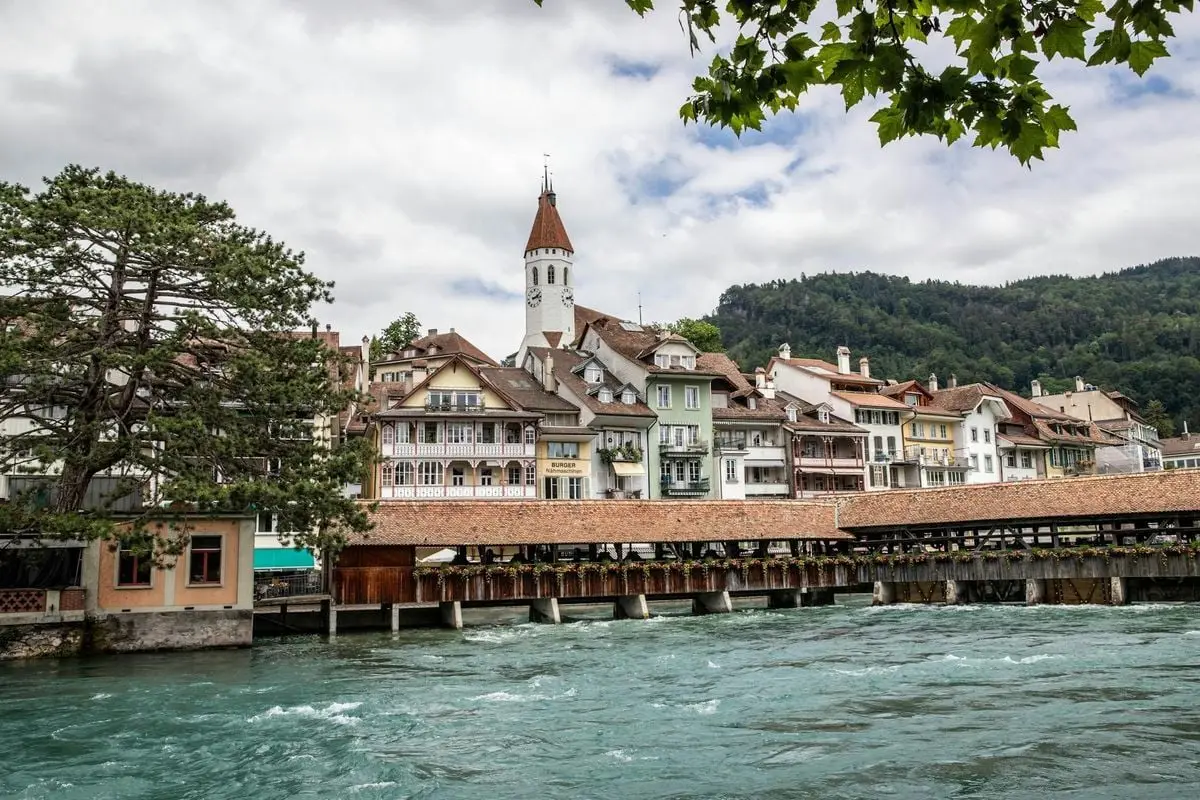 Picturesque scenery of Thun, Switzerland, featuring historic architecture and a riverside view.
