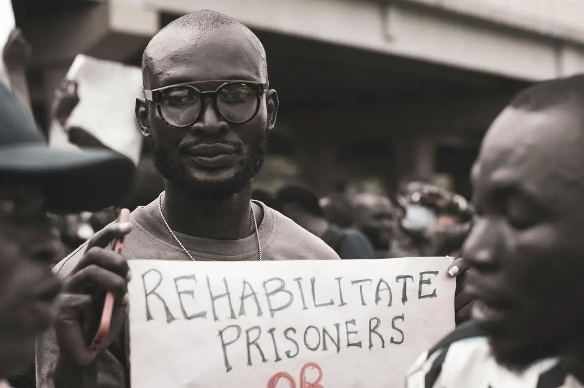 Protest capturing a man's call to rehabilitate prisoners, showcasing social activism.