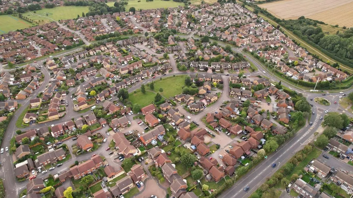 Aerial view of suburban houses in Luton, England, showcasing a vibrant residential area.