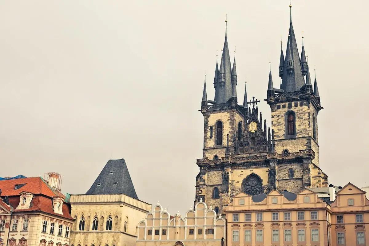 Captivating view of gothic church towers in Prague's historic cityscape.