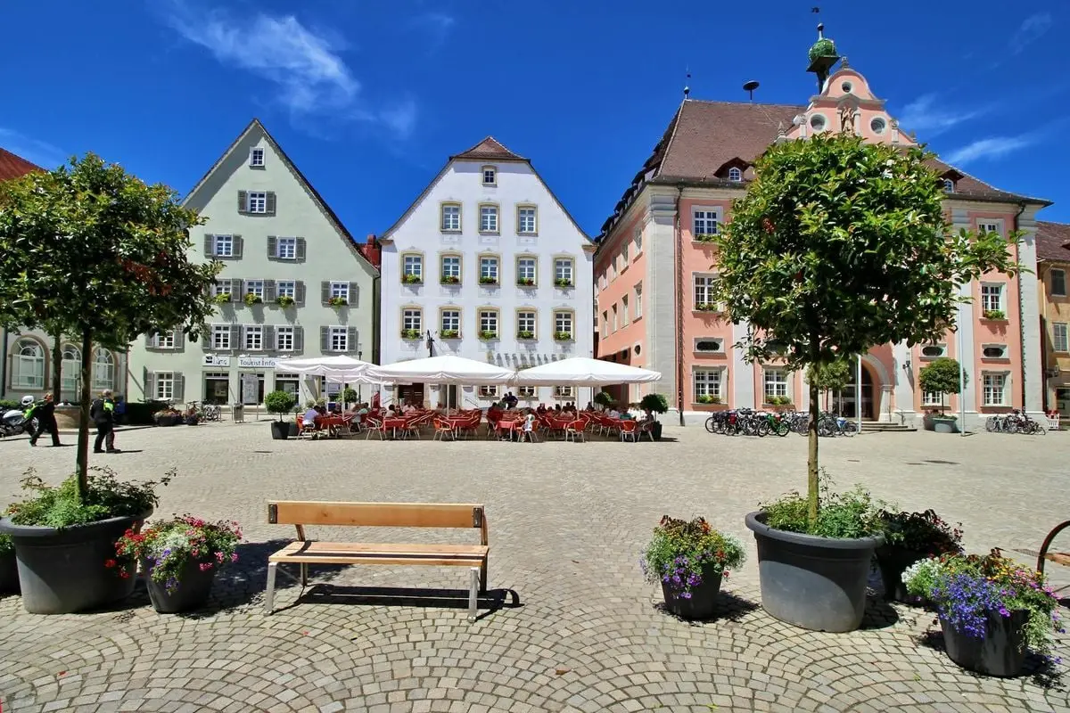 A picturesque town square in Rottenburg, Germany featuring colorful historic townhouses and a cozy outdoor cafe.