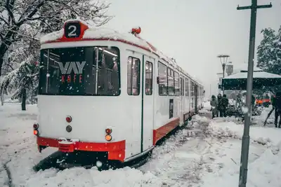 Tramway covered in snow near a café in Konya, Türkiye during a winter snowstorm.