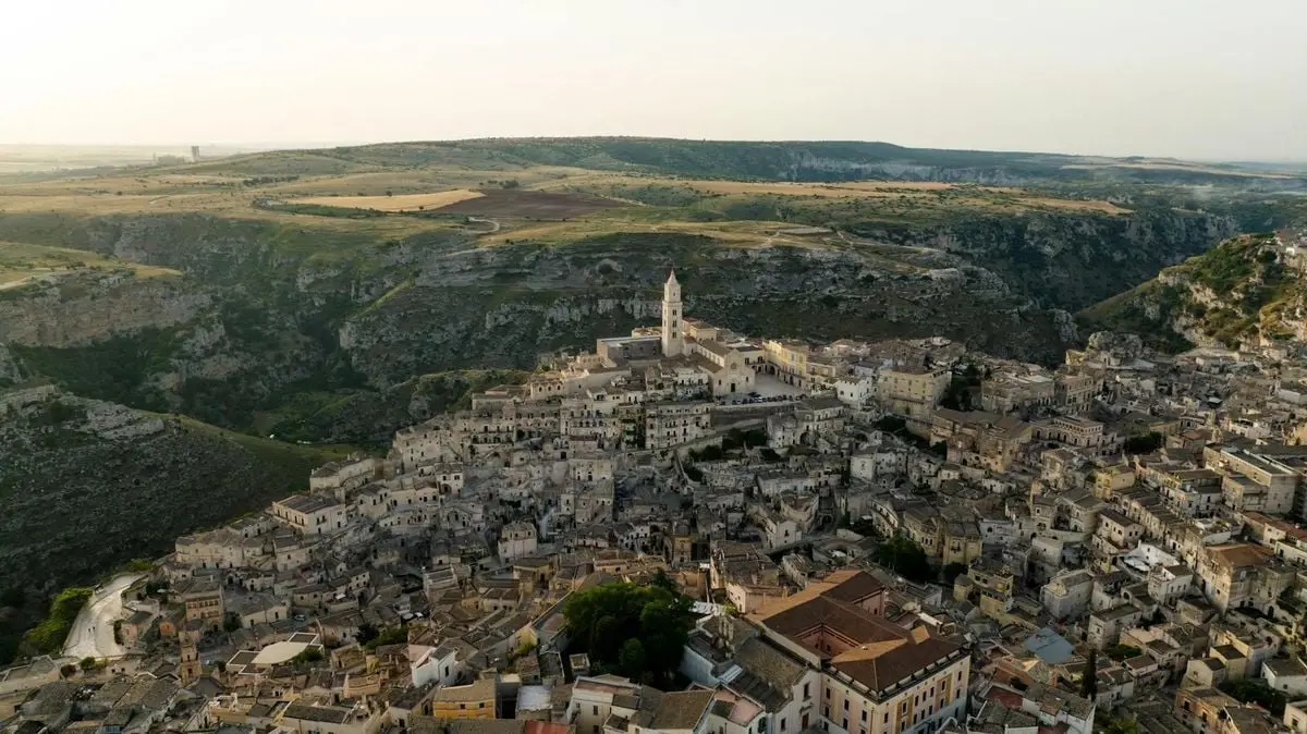 Stunning aerial view of a historic town nestled in a dramatic landscape.