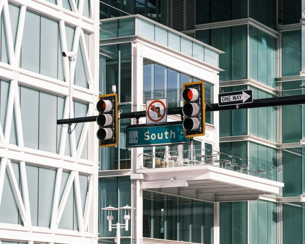 Contemporary intersection with traffic signals at South Street, featuring urban architecture and glass buildings.