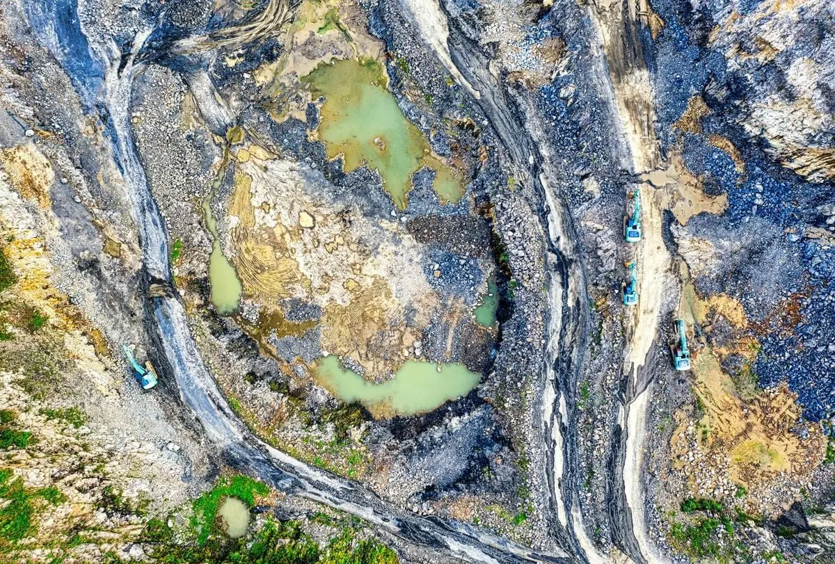 Aerial view of excavation area with backhoes and exposed earth in Rumpin, West Java, Indonesia.