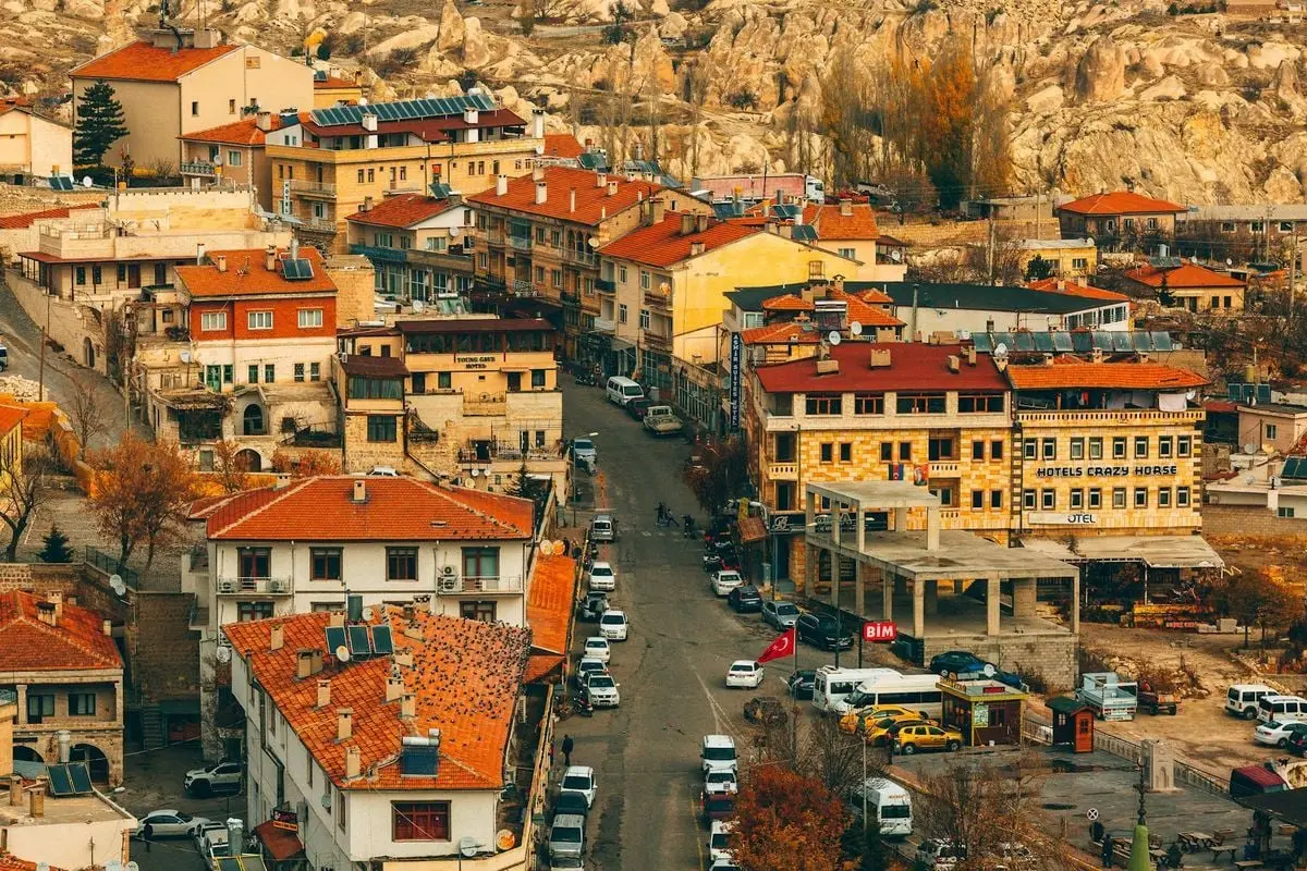 Explore the charming red-roofed townscape of Cappadocia captured from a high angle.