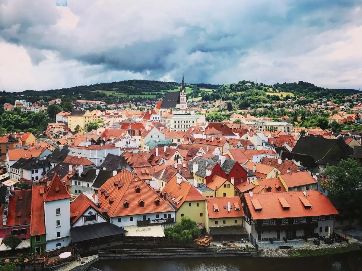 A picturesque view of Český Krumlov with its charming rooftops and surrounding nature.