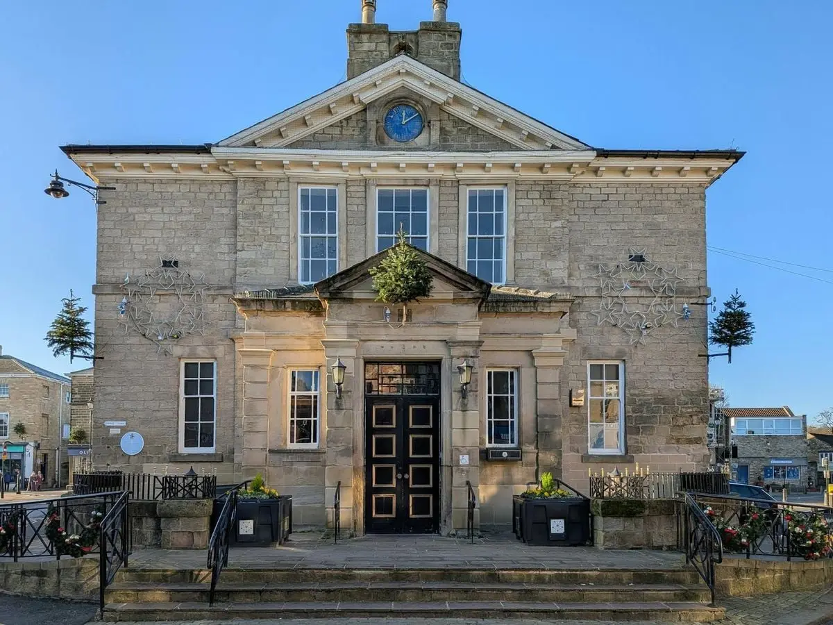 Front view of Wetherby Town Hall on a sunny day, showcasing classic architecture.