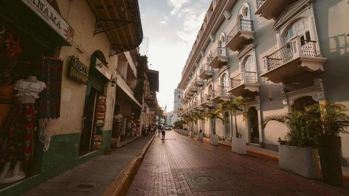 A picturesque old street in Panama City with historic buildings and lively street scene at sunset.