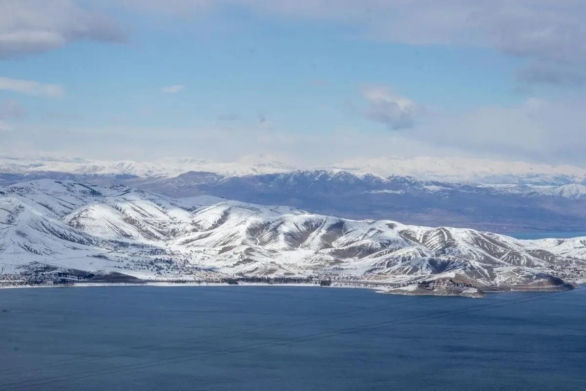 A breathtaking view of snow-capped mountains and a serene lake in Sivrice, Elazığ, Türkiye.