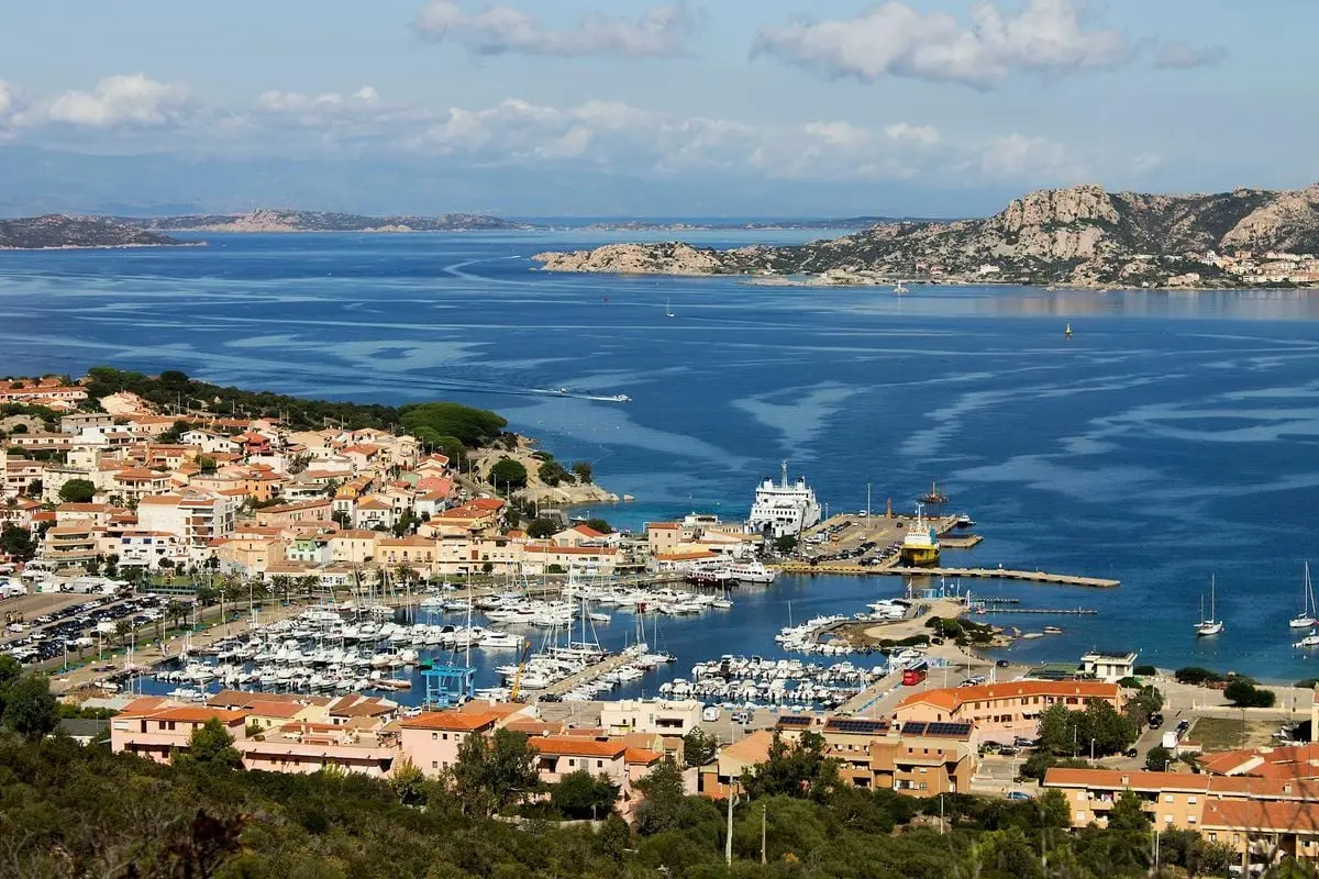 Scenic aerial shot of Palau harbor and town in Sardinia, showcasing vibrant coastal life.