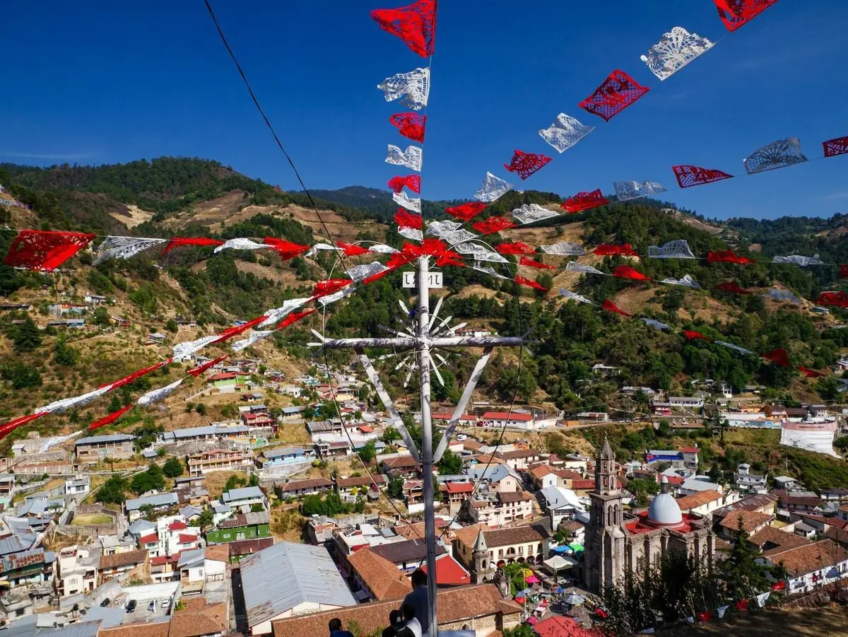 Colorful papel picado flags adorn the hillside view of Angangueo, Michoacán, México.
