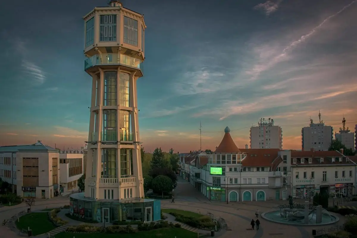 Picturesque Siófok view featuring iconic water tower during twilight, showcasing beautiful architecture and serene skyline.