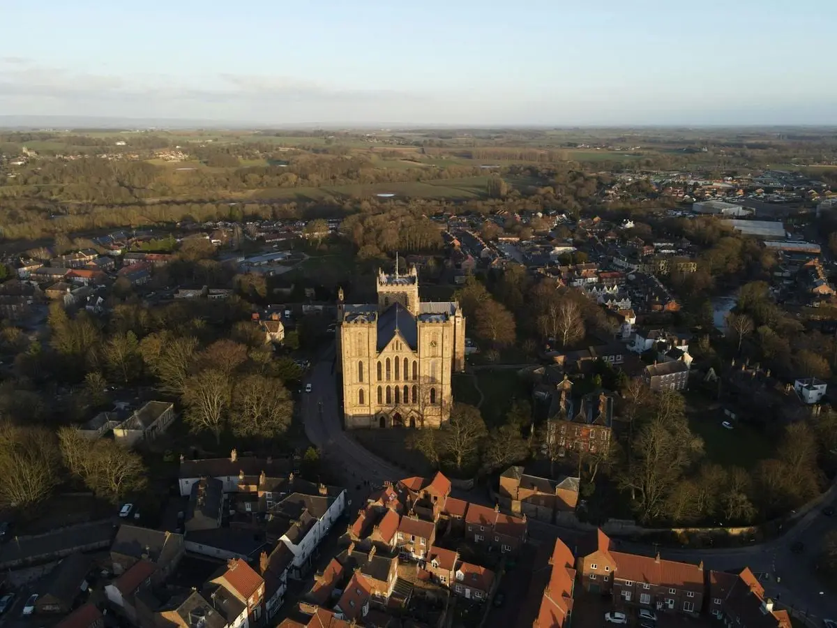 Stunning aerial view of Ripon Cathedral, a historical landmark in Yorkshire, surrounded by countryside.