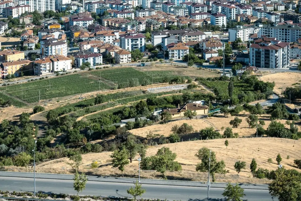 Aerial photograph showcasing Elâzığ's urban and rural contrast during summer.