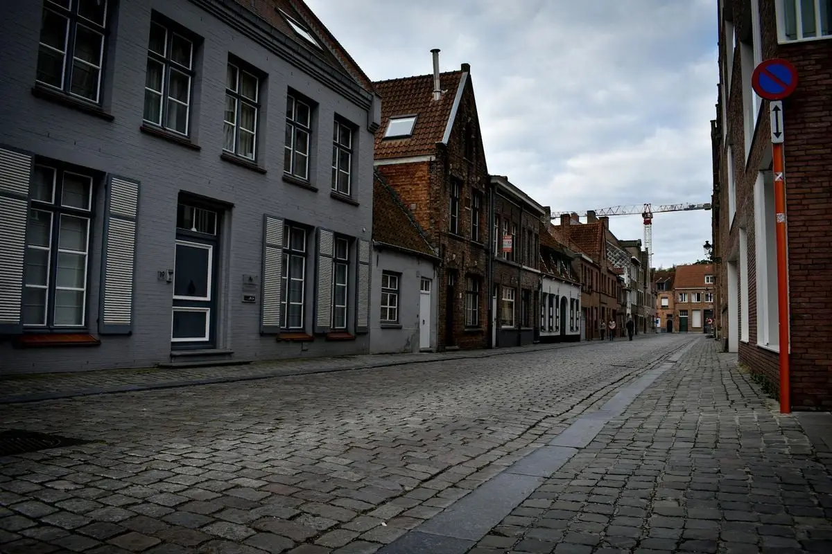 Quaint European street with cobblestone pavement and historic architecture.
