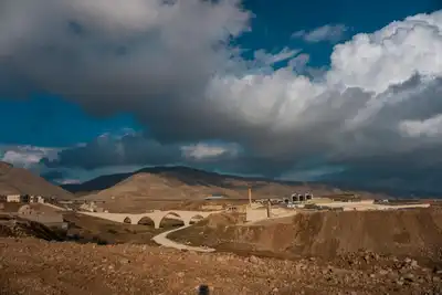 Dramatic landscape featuring Hasankeyf's ancient bridge under a captivating sky in Turkey.