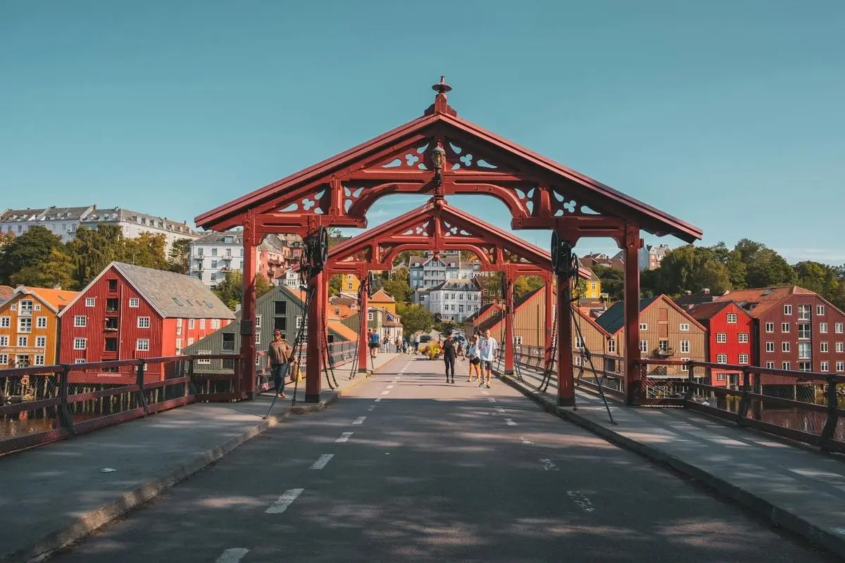 Charming view of the Old Town Bridge in Trondheim, Norway, with colorful wooden houses.