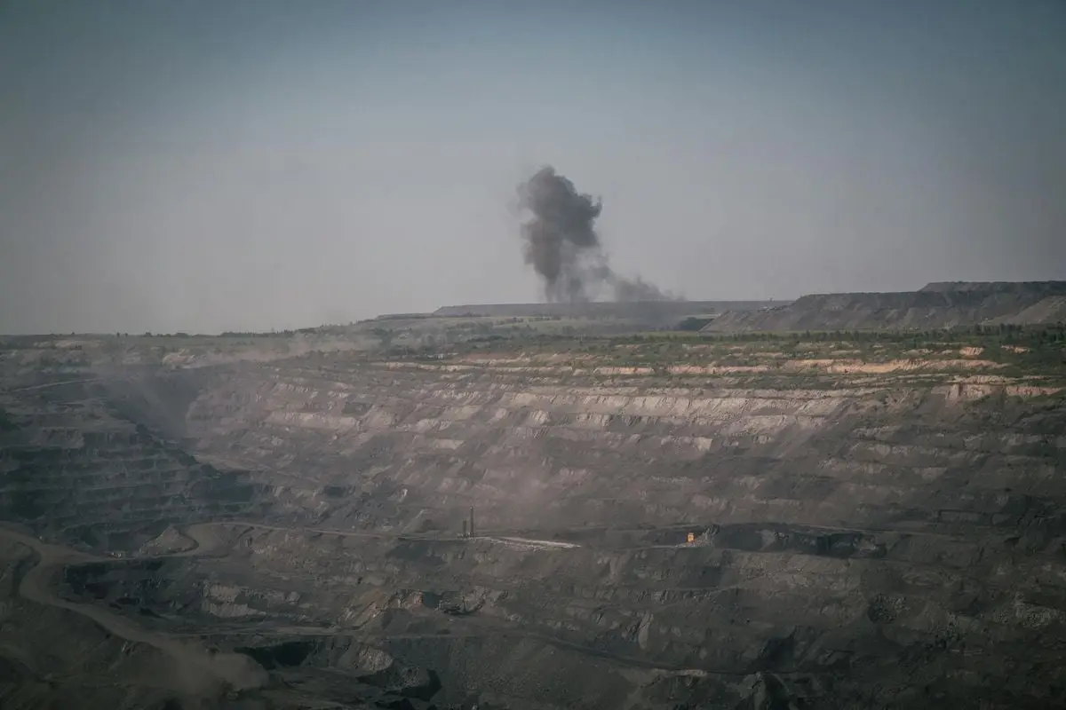 Aerial shot of the smoky quarry in Novokuznetsk, Russia, showing industrial mining activity.
