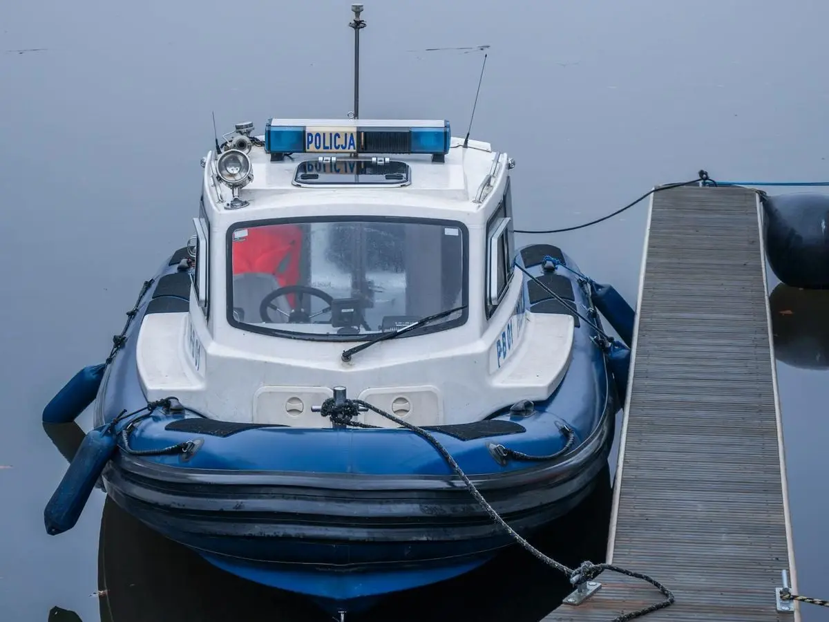 A Polish police boat docked, showcasing nautical safety and security.