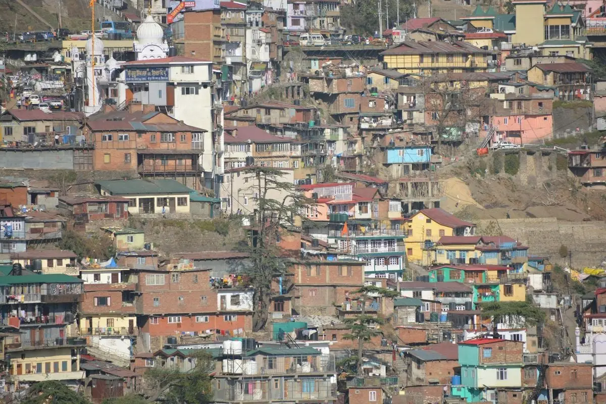 Colorful hillside homes in Shimla, Himachal Pradesh showcasing the unique architecture and vibrant community.