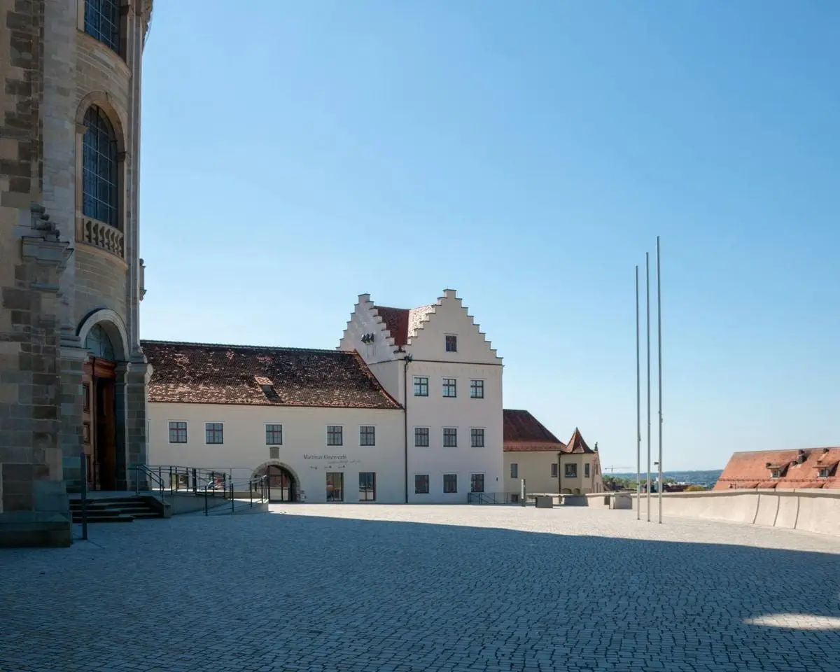 Scenic view of historic buildings in Weingarten, Germany under clear blue sky.