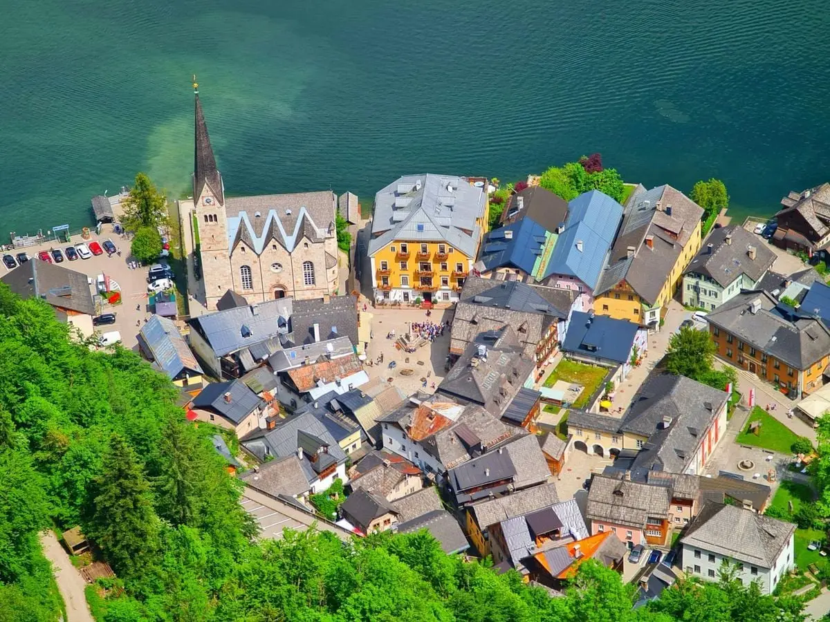 Scenic aerial view of Hallstatt, Austria with iconic lake and historic Lutheran church.