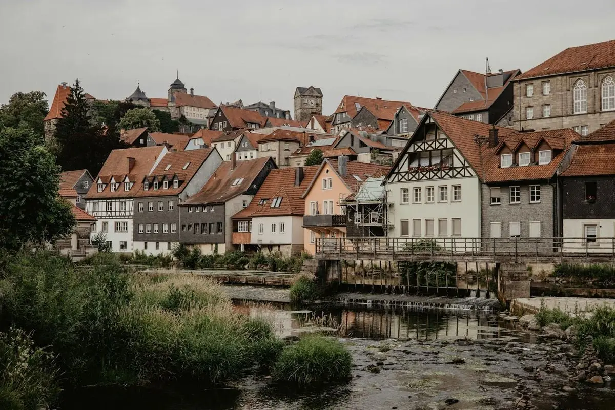 Charming village in Germany showcasing traditional half-timbered houses by a serene river.