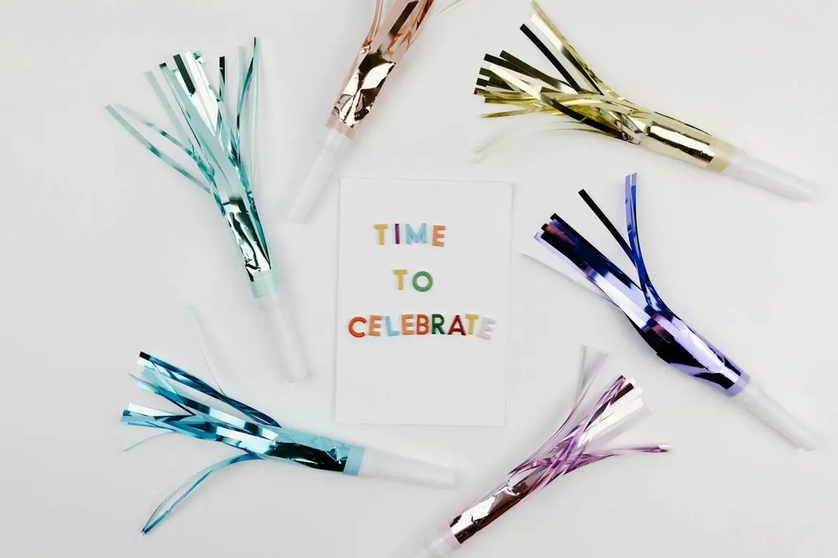 Colorful party blowers and a card with 'Time to Celebrate' for festive occasions.
