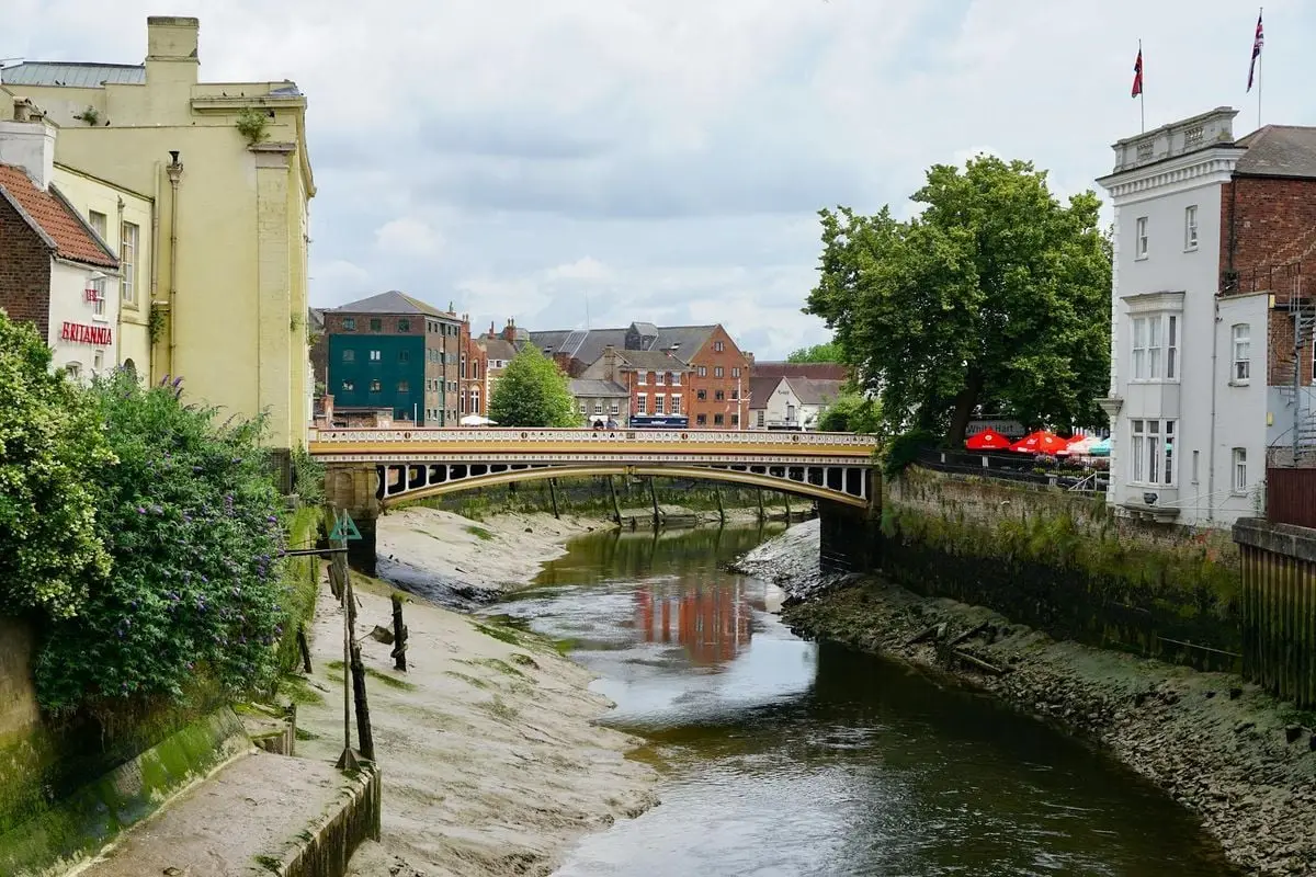 Scenic view of a historic bridge over a river in Boston, England, surrounded by charming architecture.