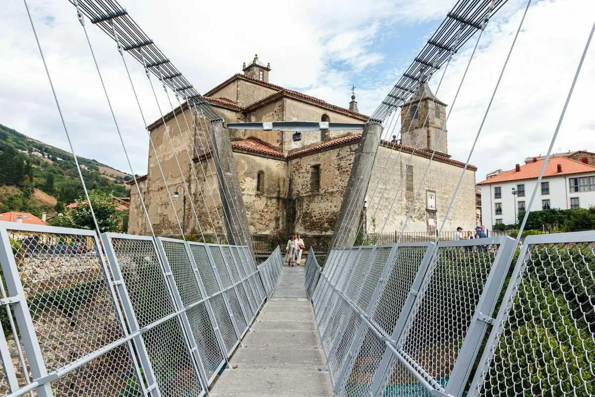 Explore the historic church and footbridge in Cangas del Narcea, Asturias, Spain.