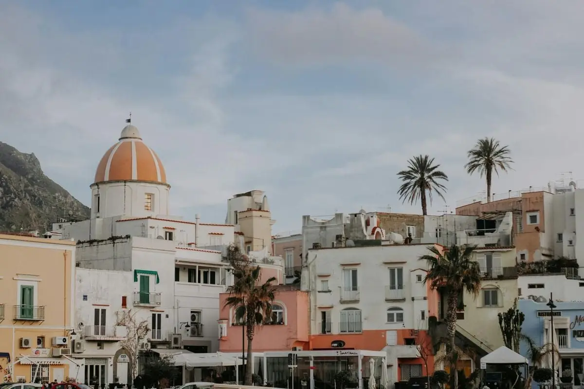 Charming view of the colorful buildings and church in Forio, Ischia Island, perfect for travel enthusiasts.