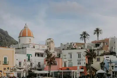 Charming view of the colorful buildings and church in Forio, Ischia Island, perfect for travel enthusiasts.