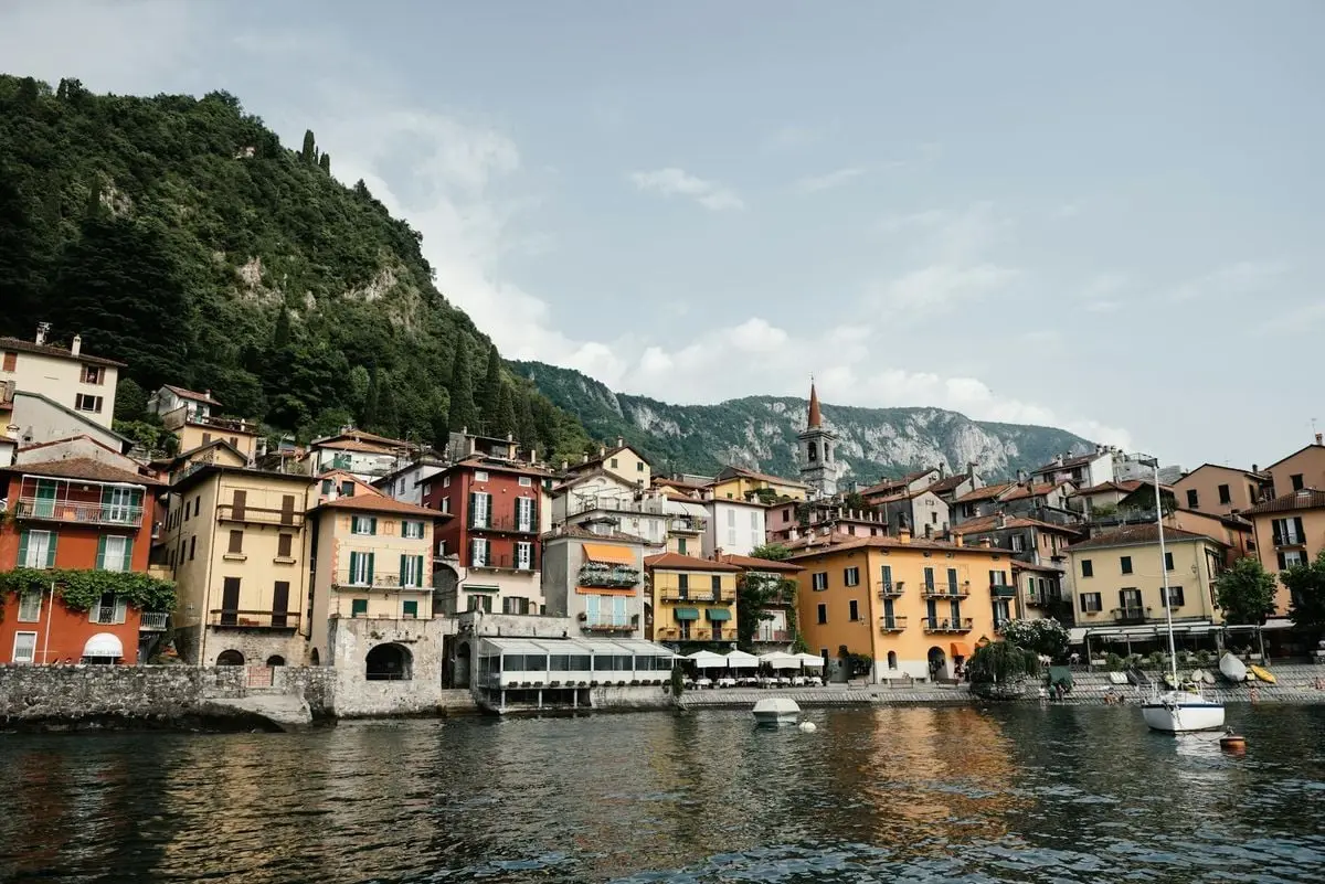 View of Varenna's vibrant waterfront with colorful houses by Lake Como, Italy.