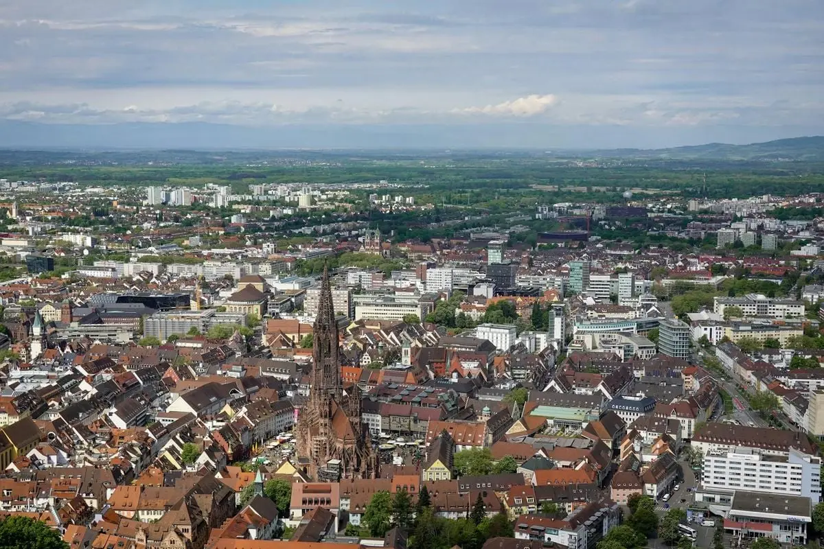 A breathtaking aerial view of Freiburg's historic architecture against lush greenery.