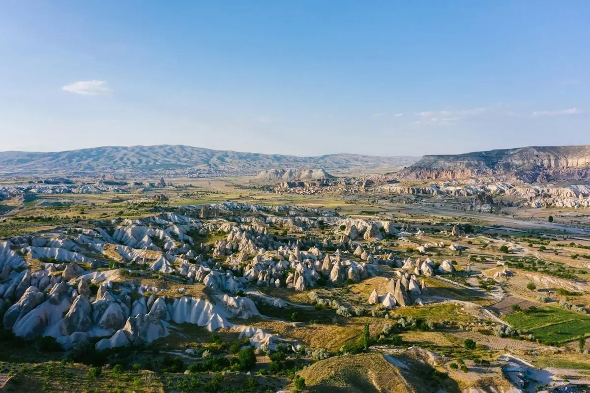 Explore the stunning rock formations and vast scenery of Cappadocia, Turkey from above.