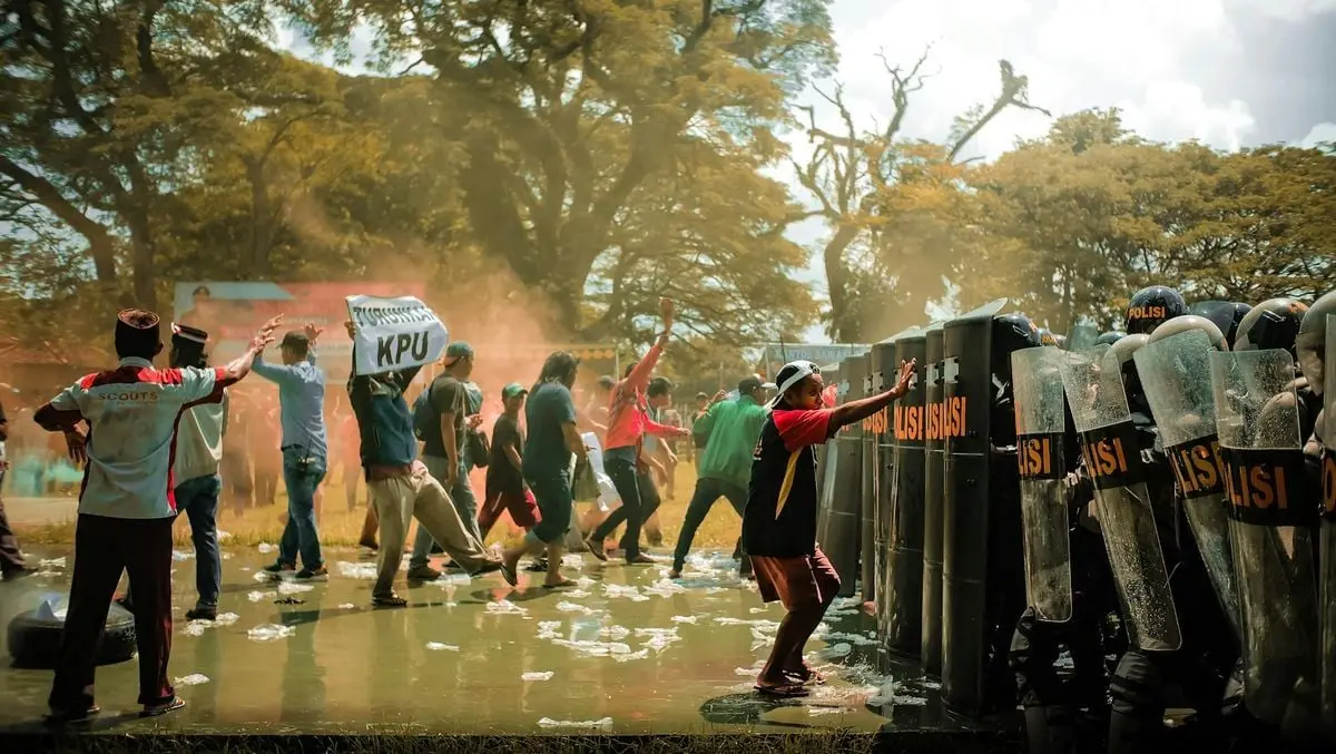 A chaotic protest captured in Bangkalan, East Java, with police and demonstrators clashing.